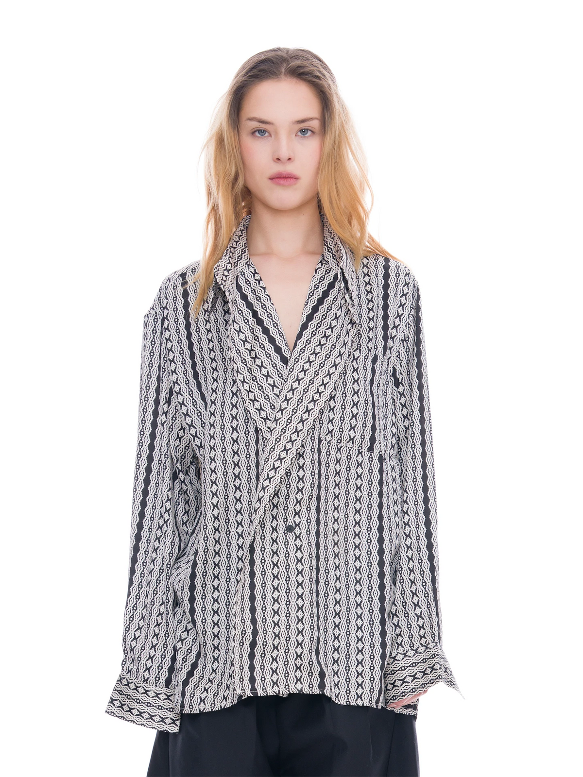 A model wearing a black and white vertically patterned wrap-style shirt jacket with a collar, photographed against a solid white background.